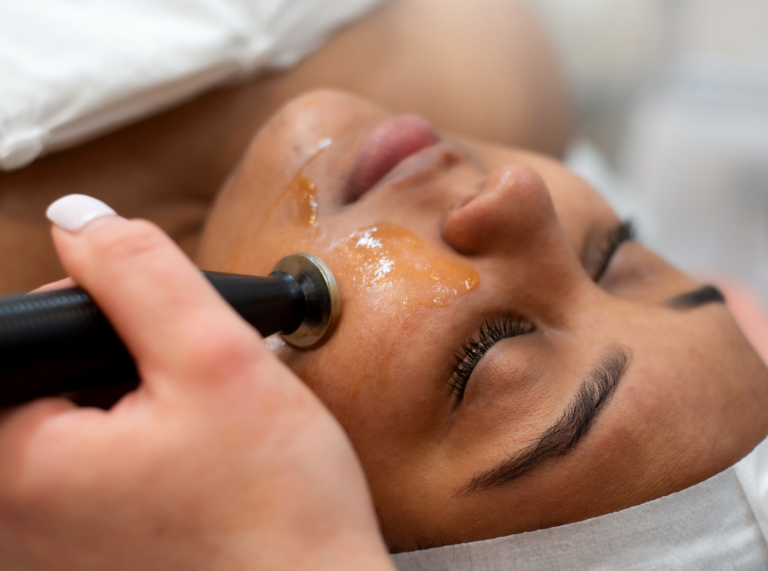 Client receiving Environ facial treatment with vitamin-based skincare device.